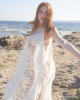 <p>Feel the ocean breeze and move with the waves in this effortlessly chic beach cover-up from the <em>Aurales Bohemian Collection</em>. With its flowing, fringed design, this piece adds movement and texture to any beach ensemble, creating a sense of freedom and lightness. The soft, cream tones blend harmoniously with the coastal backdrop, offering an ethereal and serene look perfect for seaside adventures. Whether you're strolling along the shore or catching the sunset, this cover-up captures the essence of bohemian elegance and carefree summer days.</p>